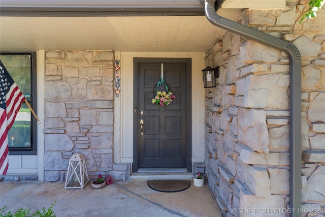 entrance to property with stone siding