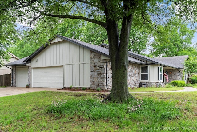 ranch-style house featuring roof with shingles, an attached garage, stone siding, driveway, and a front lawn