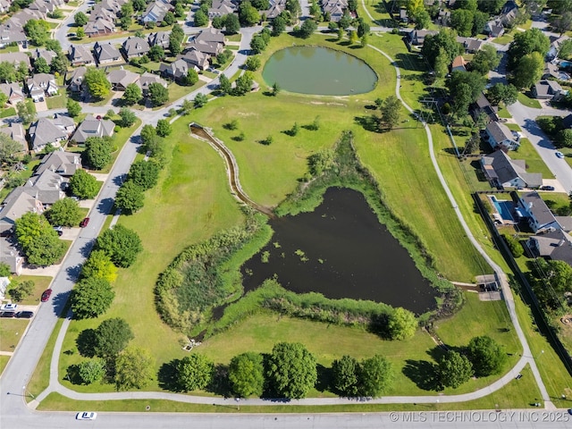 drone / aerial view with a water view and a residential view