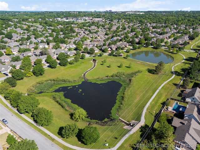 drone / aerial view with a water view and a residential view