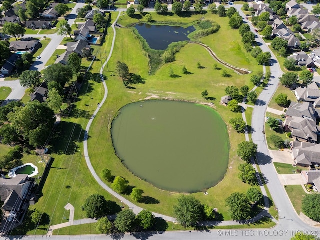 drone / aerial view with a water view and a residential view
