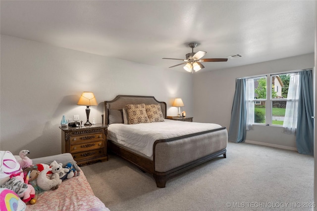 bedroom featuring ceiling fan, light carpet, baseboards, and visible vents
