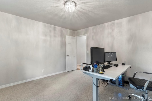 carpeted home office with baseboards and a notable chandelier