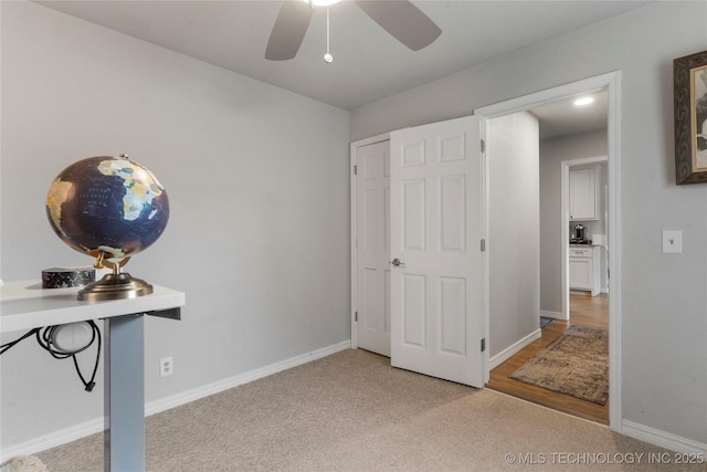 home office with carpet, baseboards, and a ceiling fan