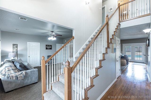 12285 N 164th E Pl, Collinsville, OK 74021 - stairs featuring a ceiling fan, wood finished floors, and a towering ceiling
