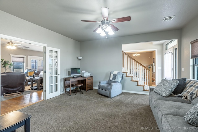 carpeted living area with a ceiling fan, french doors, baseboards, visible vents, and stairway