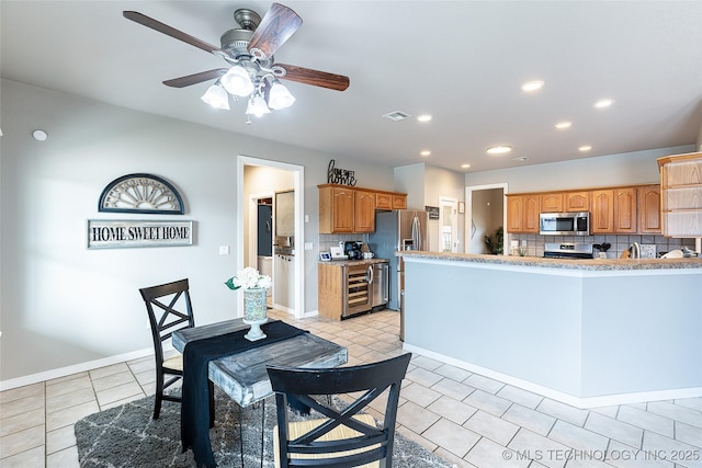 kitchen with visible vents, wine cooler, backsplash, appliances with stainless steel finishes, and recessed lighting