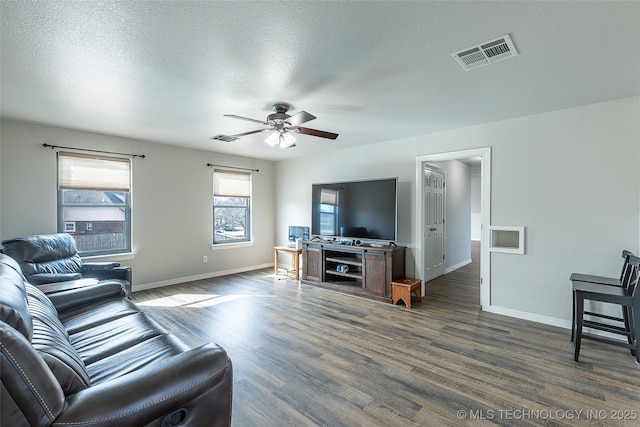 12285 N 164th E Pl, Collinsville, OK 74021 - living room with dark wood-style floors, a ceiling fan, and a textured ceiling