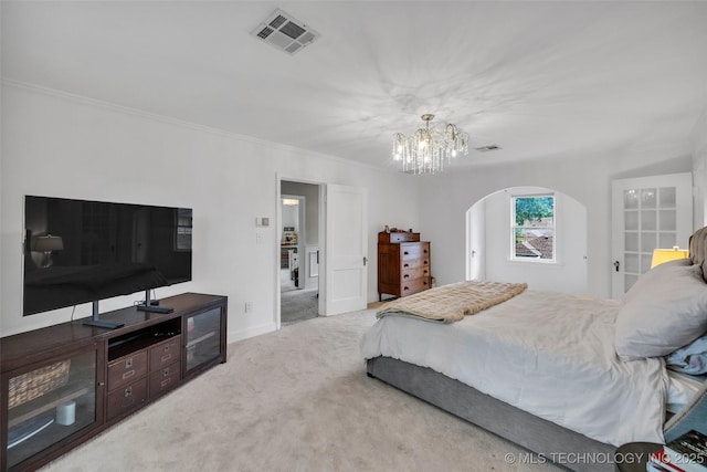 bedroom with visible vents, an inviting chandelier, crown molding, carpet floors, and arched walkways