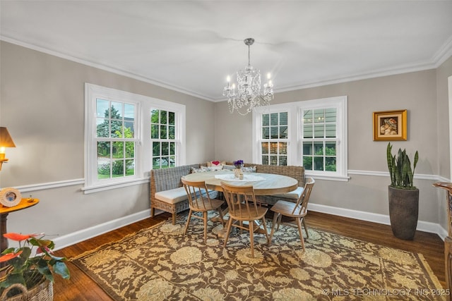 dining space with an inviting chandelier, a wealth of natural light, wood finished floors, and ornamental molding