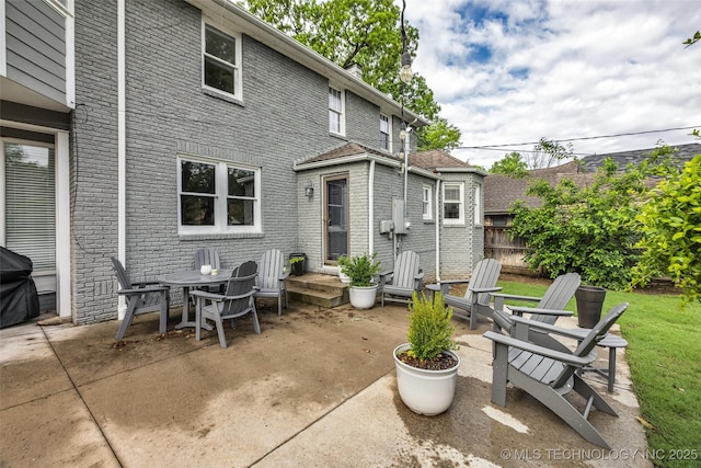 view of patio / terrace featuring fence and a grill