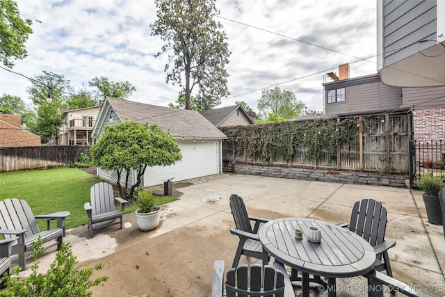 view of patio / terrace with a fenced backyard, an outdoor structure, and a garage