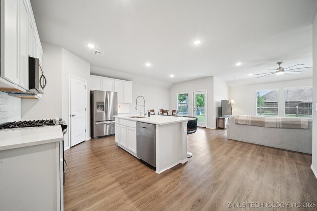 4218 W Village Park Dr, Skiatook, OK 74070 - kitchen with light wood-style flooring, a sink, open floor plan, visible vents, and appliances with stainless steel finishes