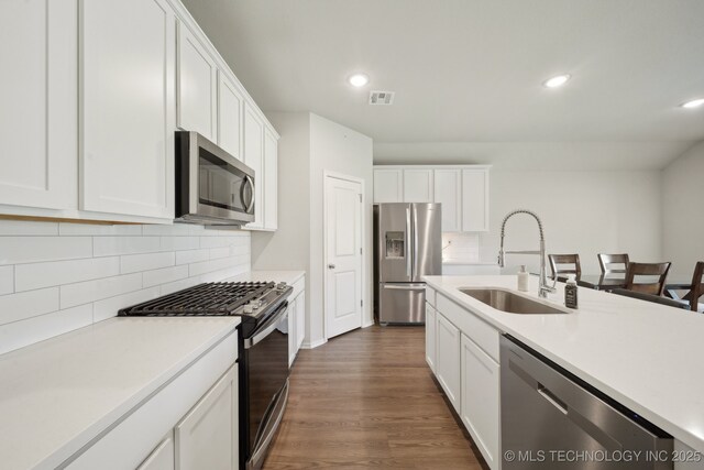 4218 W Village Park Dr, Skiatook, OK 74070 - kitchen with visible vents, a sink, white cabinetry, light countertops, and appliances with stainless steel finishes