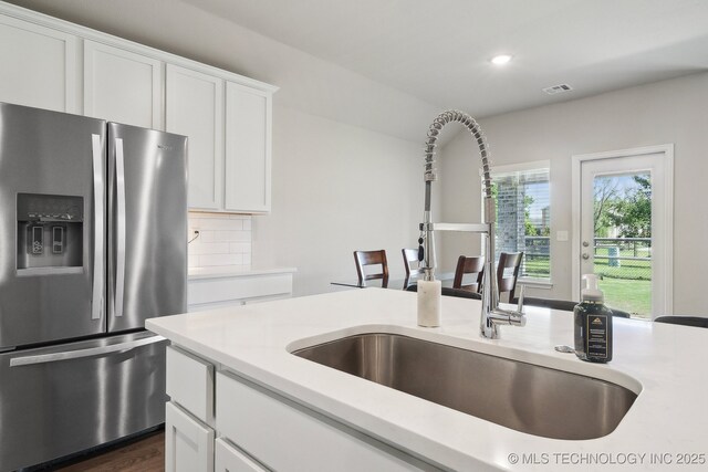 4218 W Village Park Dr, Skiatook, OK 74070 - kitchen with a sink, stainless steel fridge with ice dispenser, light countertops, and white cabinets