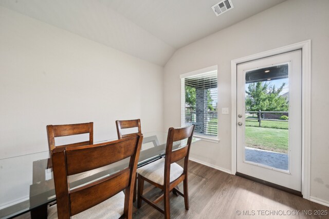 4218 W Village Park Dr, Skiatook, OK 74070 - dining space with lofted ceiling, baseboards, visible vents, and wood finished floors