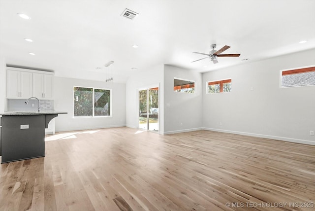 13242 E 4th Pl, Tulsa, OK 74108 - unfurnished living room with light wood finished floors, visible vents, baseboards, and recessed lighting