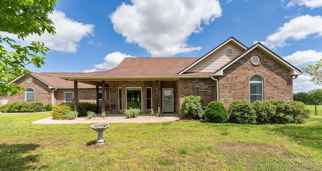 ranch-style house with a front lawn and brick siding