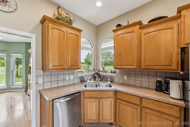 kitchen with dishwasher, plenty of natural light, light countertops, and a sink