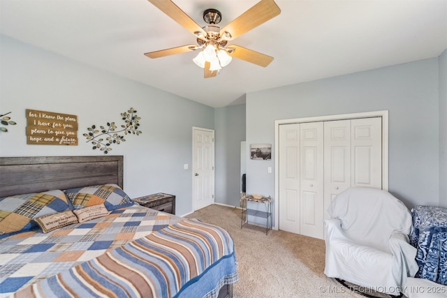 carpeted bedroom with ceiling fan and a closet