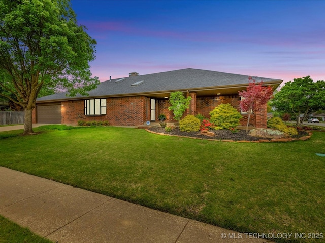 2600 Chapel Hill Rd, Bartlesville, OK 74006 - view of front of home with an attached garage, brick siding, a front lawn, and concrete driveway