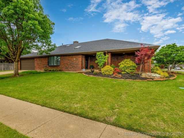 2600 Chapel Hill Rd, Bartlesville, OK 74006 - view of front of home featuring an attached garage, brick siding, driveway, and roof with shingles