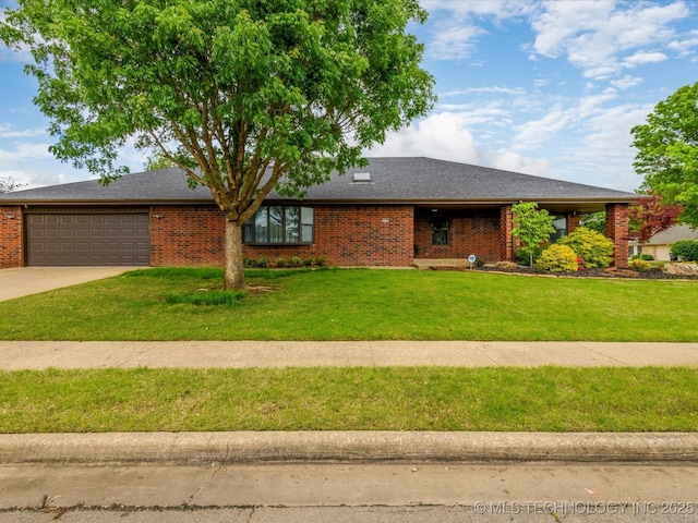 2600 Chapel Hill Rd, Bartlesville, OK 74006 - view of front of property with a garage, a front lawn, concrete driveway, and brick siding