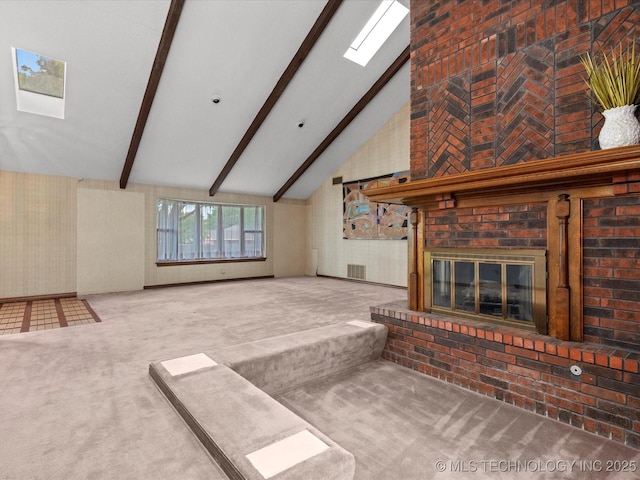 2600 Chapel Hill Rd, Bartlesville, OK 74006 - unfurnished living room with carpet floors, beamed ceiling, a brick fireplace, high vaulted ceiling, and a skylight