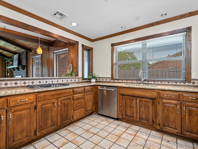 2600 Chapel Hill Rd, Bartlesville, OK 74006 - kitchen with stainless steel appliances, a sink, decorative light fixtures, light tile patterned floors, and brown cabinets