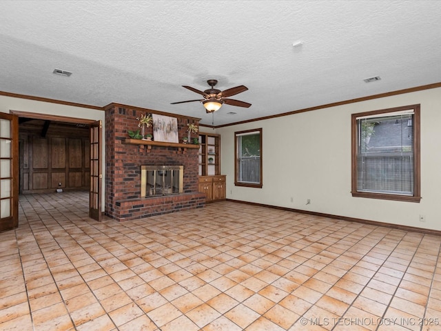 2600 Chapel Hill Rd, Bartlesville, OK 74006 - unfurnished living room with ceiling fan, a fireplace, a textured ceiling, baseboards, and ornamental molding