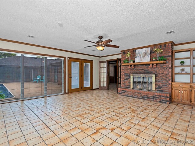 2600 Chapel Hill Rd, Bartlesville, OK 74006 - unfurnished living room featuring a fireplace, crown molding, ceiling fan, and a textured ceiling