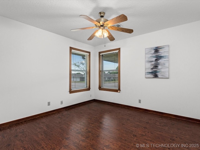 2600 Chapel Hill Rd, Bartlesville, OK 74006 - unfurnished room with dark wood-type flooring, baseboards, and a ceiling fan