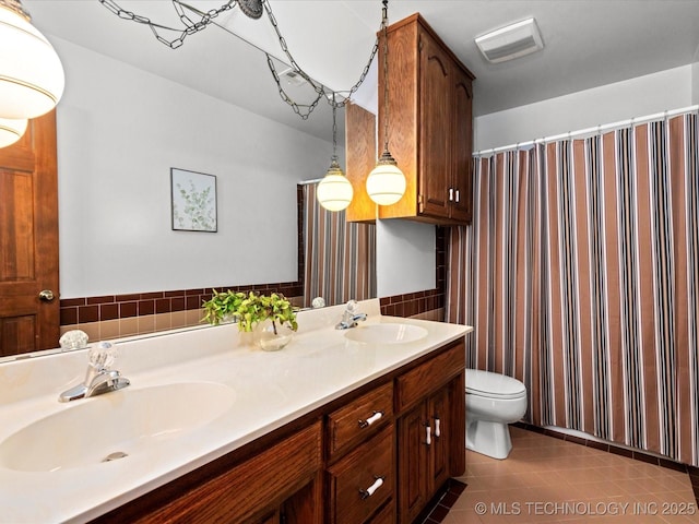 2600 Chapel Hill Rd, Bartlesville, OK 74006 - full bathroom featuring toilet, double vanity, tile patterned floors, and curtained shower
