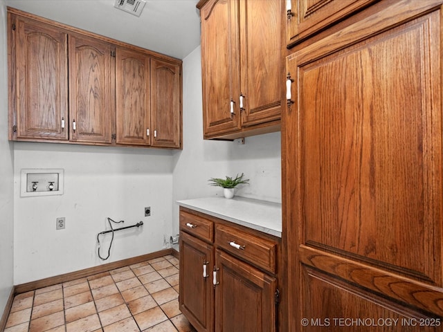 2600 Chapel Hill Rd, Bartlesville, OK 74006 - laundry area featuring hookup for an electric dryer, hookup for a gas dryer, washer hookup, baseboards, and cabinet space