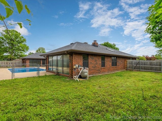 2600 Chapel Hill Rd, Bartlesville, OK 74006 - back of property with brick siding, a sunroom, and a chimney