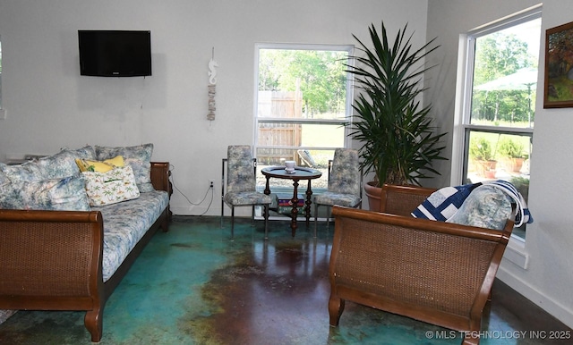 interior space featuring finished concrete floors and baseboards