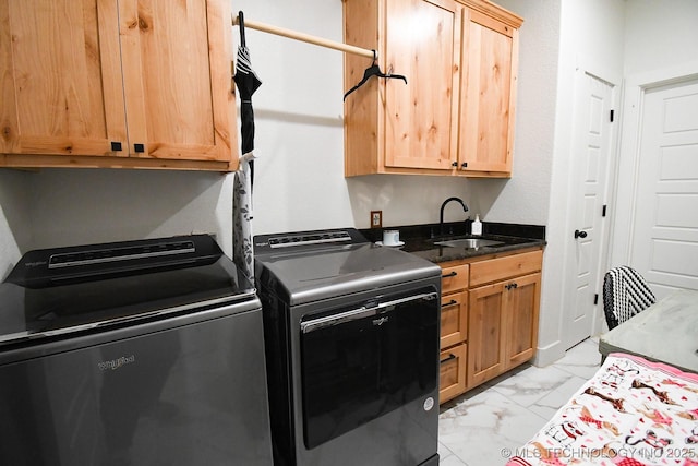 laundry area with a sink, washer and clothes dryer, cabinet space, and marble finish floor
