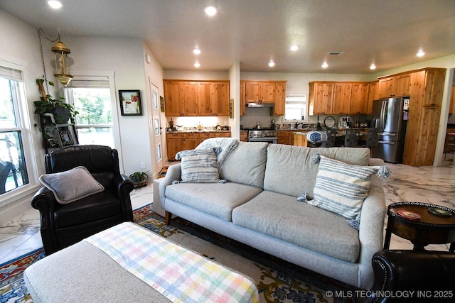 living area featuring marble finish floor and recessed lighting