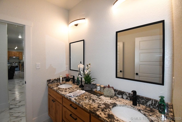 full bathroom with a sink, double vanity, and marble finish floor