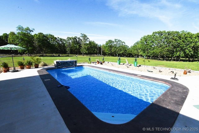 outdoor pool with a patio and a lawn
