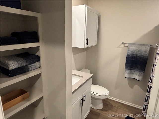 4242 W Village Park Dr, Skiatook, OK 74070 - bathroom featuring toilet, baseboards, vanity, and wood finished floors