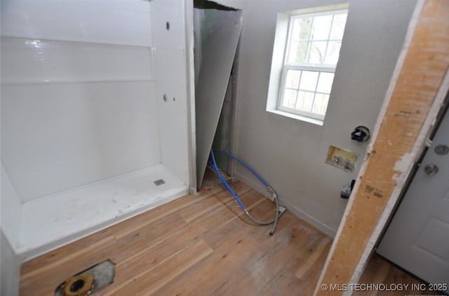 bathroom featuring walk in shower and wood finished floors
