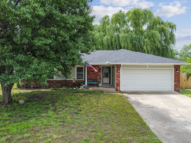 single story home featuring concrete driveway, a front yard, brick siding, and an attached garage
