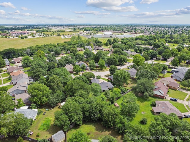 aerial view of residential area featuring a tree filled landscape