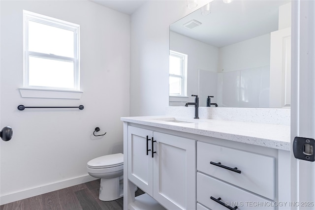 full bathroom with toilet, wood finished floors, visible vents, baseboards, and vanity