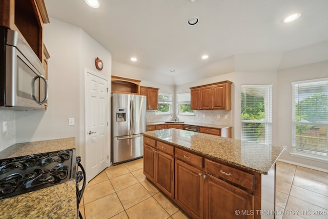 4712 N Narcissus Ave, Broken Arrow, OK 74012 - kitchen featuring appliances with stainless steel finishes, a sink, light tile patterned floors, plenty of natural light, and recessed lighting