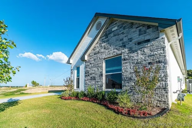 6442 E 148th St S, Bixby, OK 74008 - view of side of home featuring stone siding and a lawn