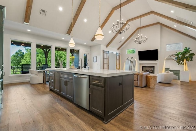 16804 E 43rd St S, Tulsa, OK 74134 - kitchen with a barn door, high vaulted ceiling, visible vents, open floor plan, and stainless steel dishwasher