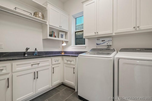 16804 E 43rd St S, Tulsa, OK 74134 - laundry area featuring washer and dryer, dark tile patterned flooring, cabinet space, and a sink