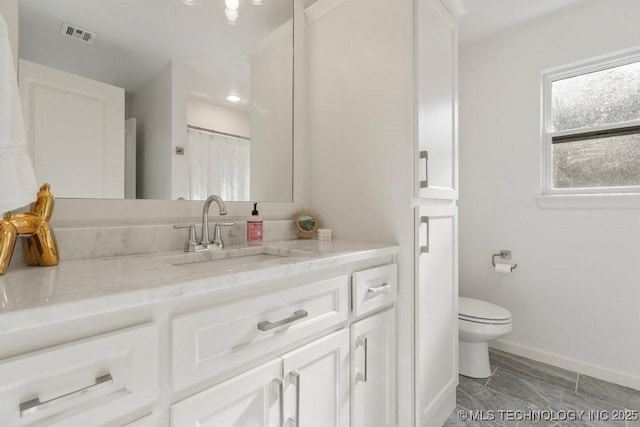 16804 E 43rd St S, Tulsa, OK 74134 - full bathroom featuring vanity, toilet, baseboards, and visible vents